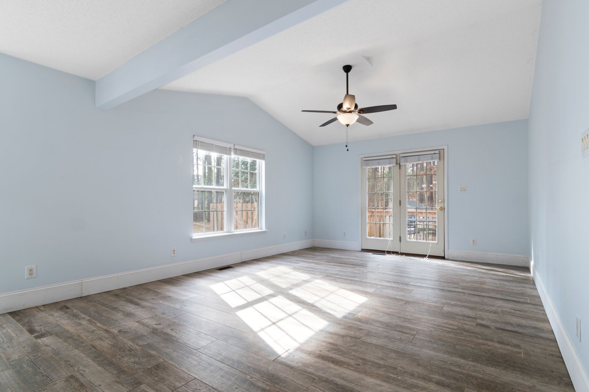 Living room with bay windows and hardwood floors