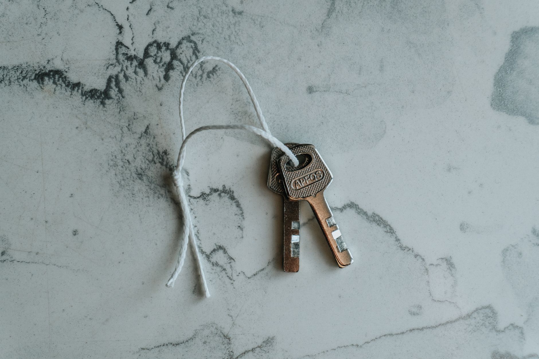 House keys resting on a stone counter